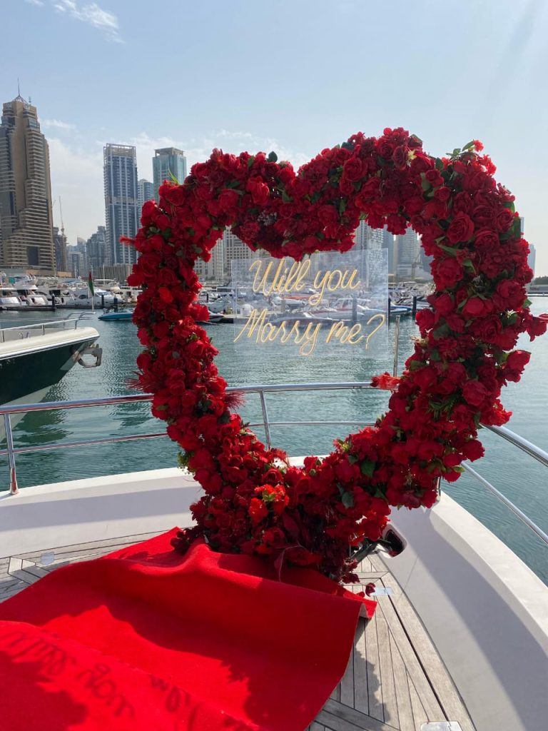 Heart-shaped red floral decoration on yacht deck for romantic proposal