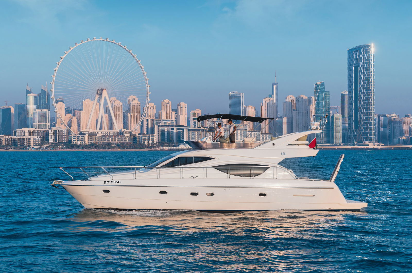 Elise 50 luxury yacht side profile cruising near Dubai skyline
