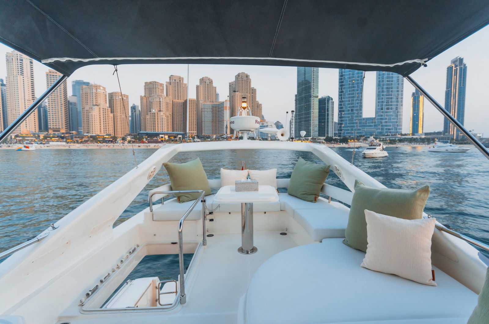 Elise 50 yacht flybridge lounge with cushioned seating and Dubai skyline view