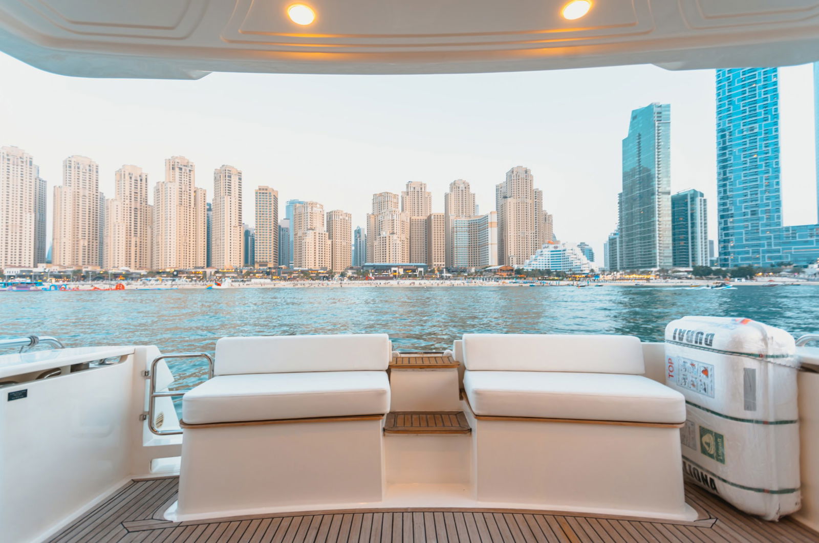 Elise 50 yacht aft deck lounge with sofa seating overlooking Dubai Marina