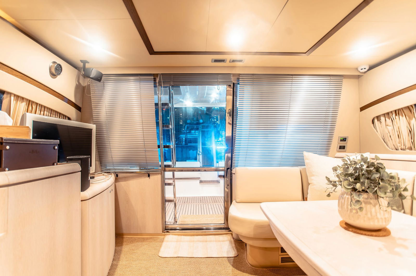 Elise 50 yacht interior lounge with sofa seating, TV, and rear deck access