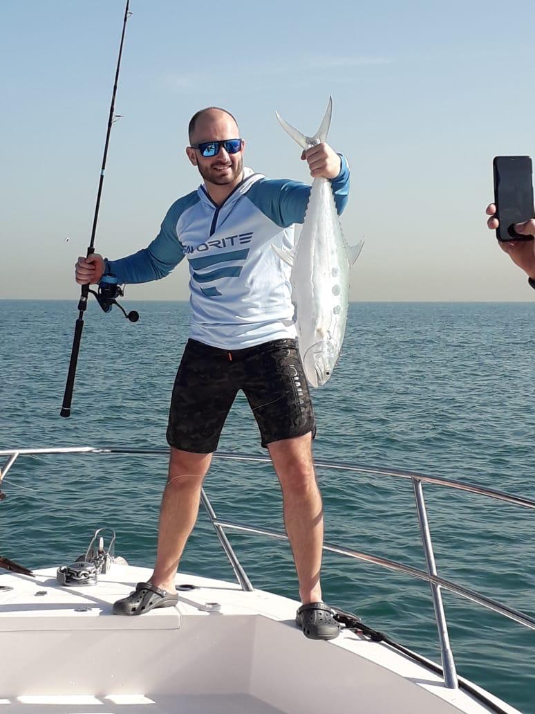Happy customer celebrating big catch on Dubai deep sea fishing trip