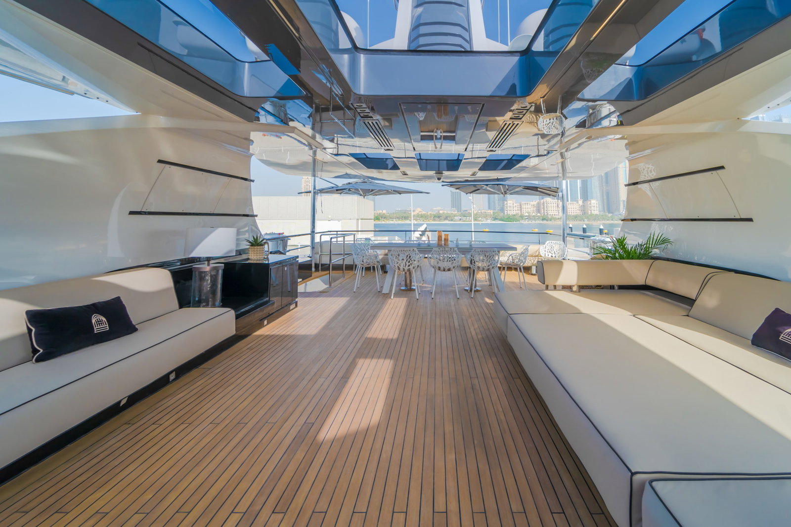 Saffuriya VIP yacht open deck lounge with teak flooring, shaded seating and spacious outdoor relaxation area
