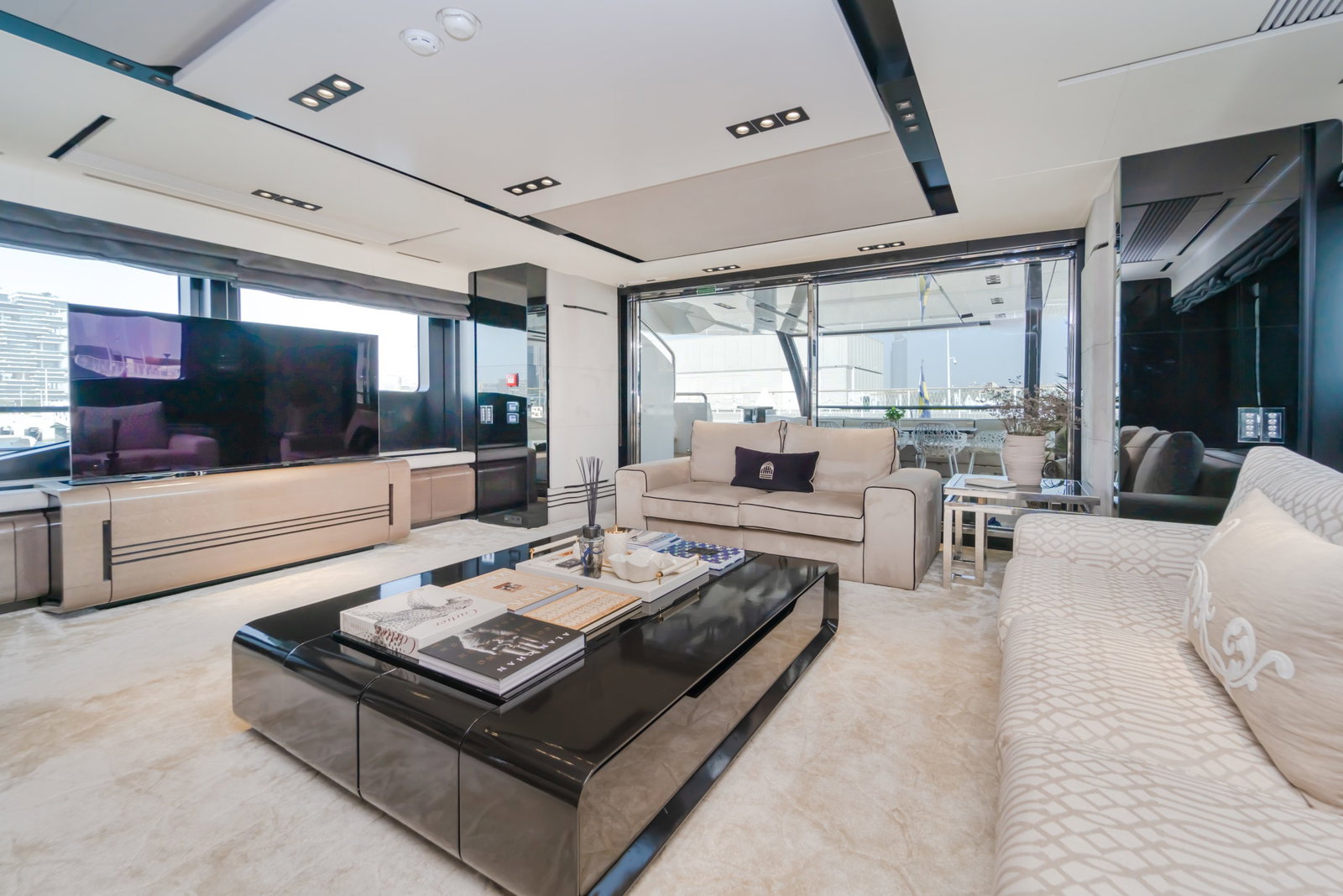 Saffuriya VIP yacht interior main lounge with luxury sofas, modern décor and large panoramic windows