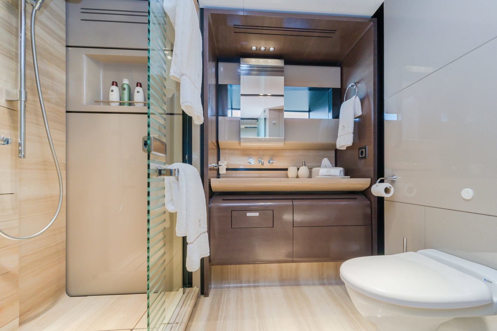 Saffuriya VIP yacht ensuite bathroom with modern vanity, glass shower enclosure and elegant wood finishes