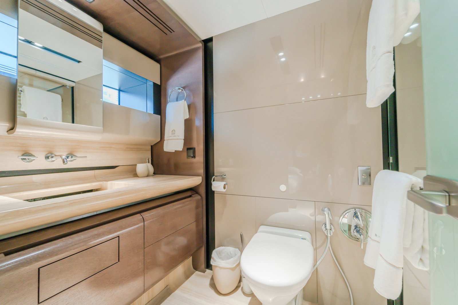 Saffuriya VIP yacht guest bathroom with glass shower, wooden cabinetry and contemporary fixtures