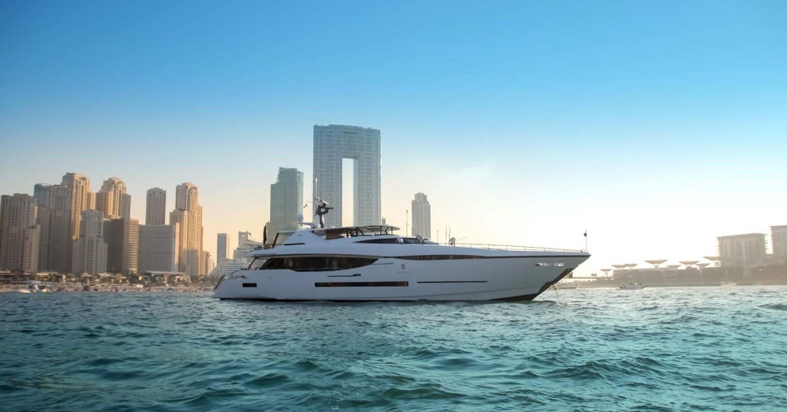 Saffuriya VIP luxury yacht cruising on calm waters with modern skyline backdrop and sleek profile