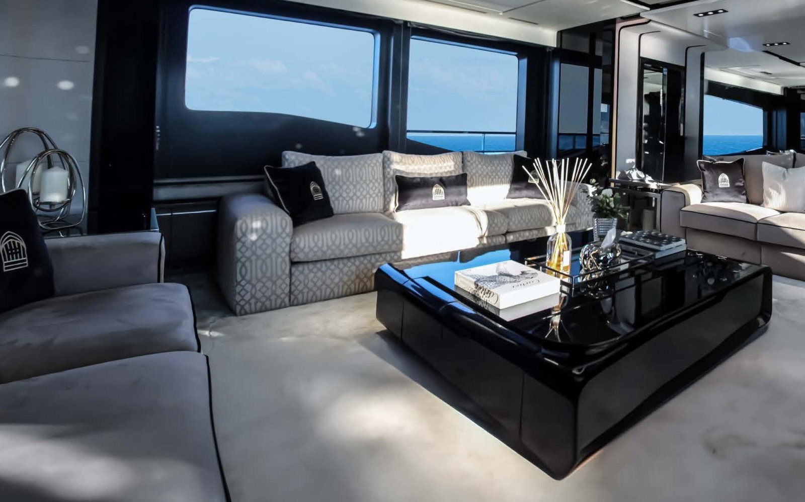 Saffuriya VIP yacht interior lounge with luxury sofa seating, panoramic windows and modern coffee table
