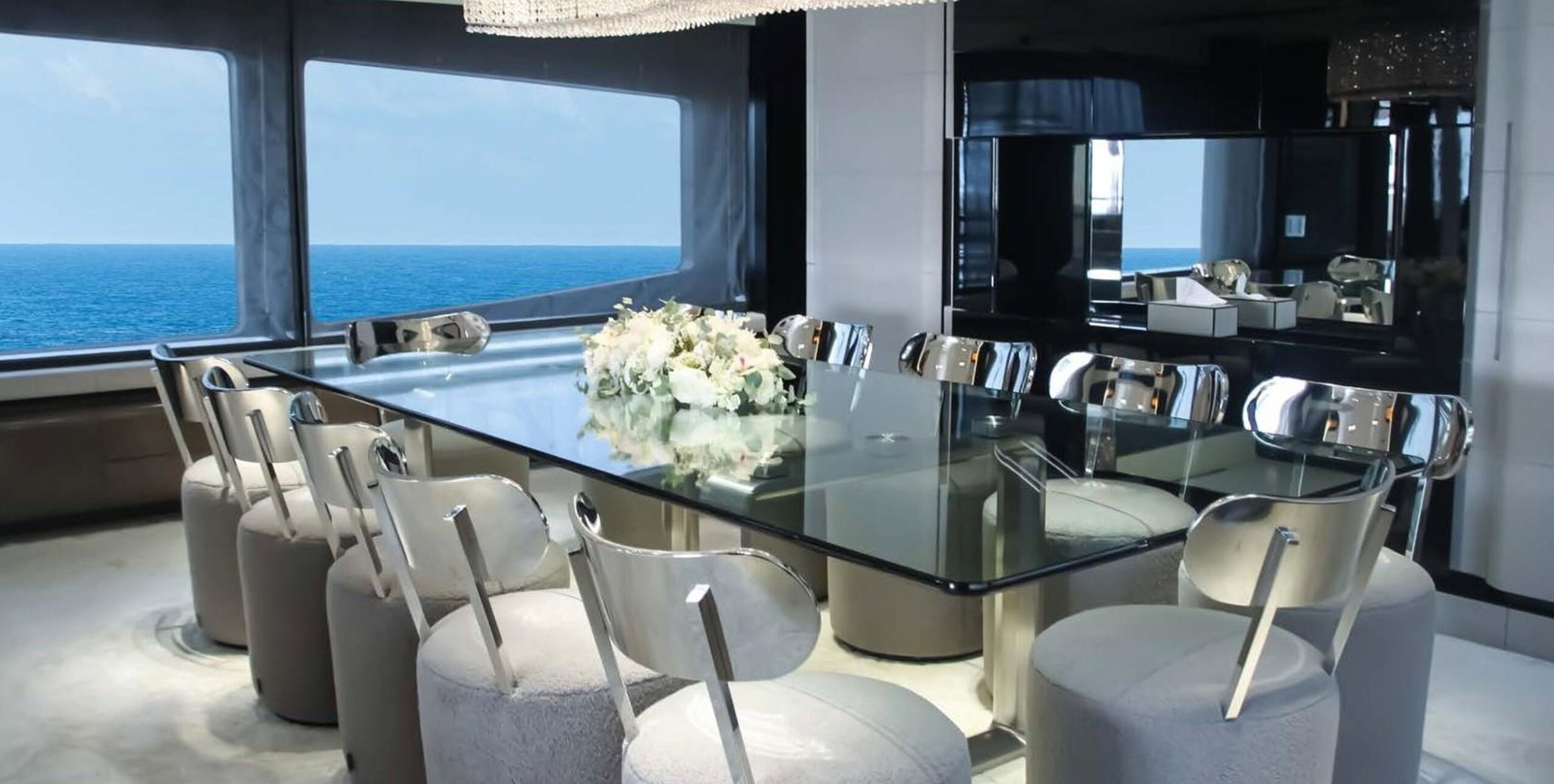 Saffuriya VIP yacht formal dining area with glass table, ocean views and elegant contemporary décor