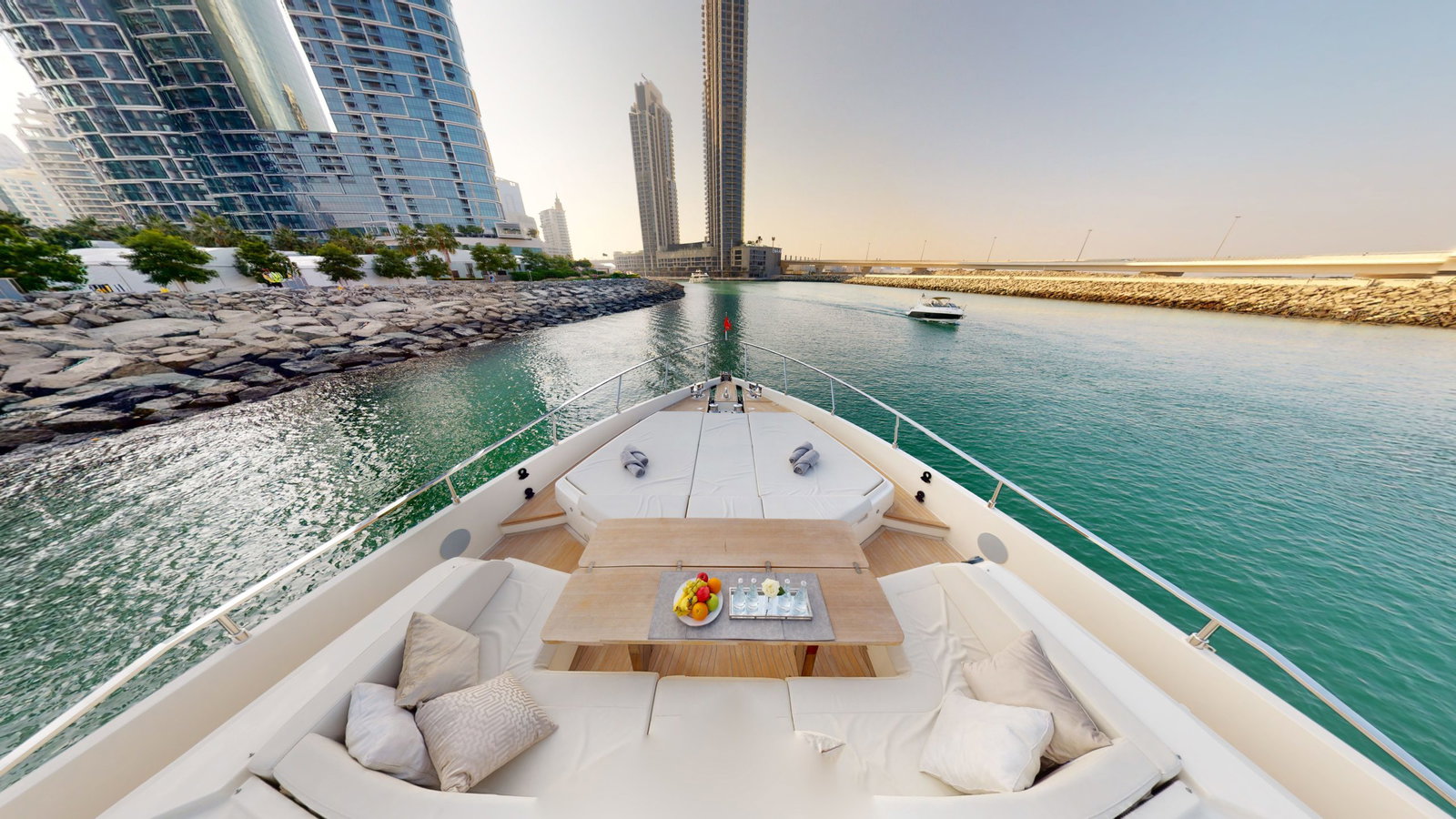 Ferretti 780 bow seating area with table overlooking Dubai Marina