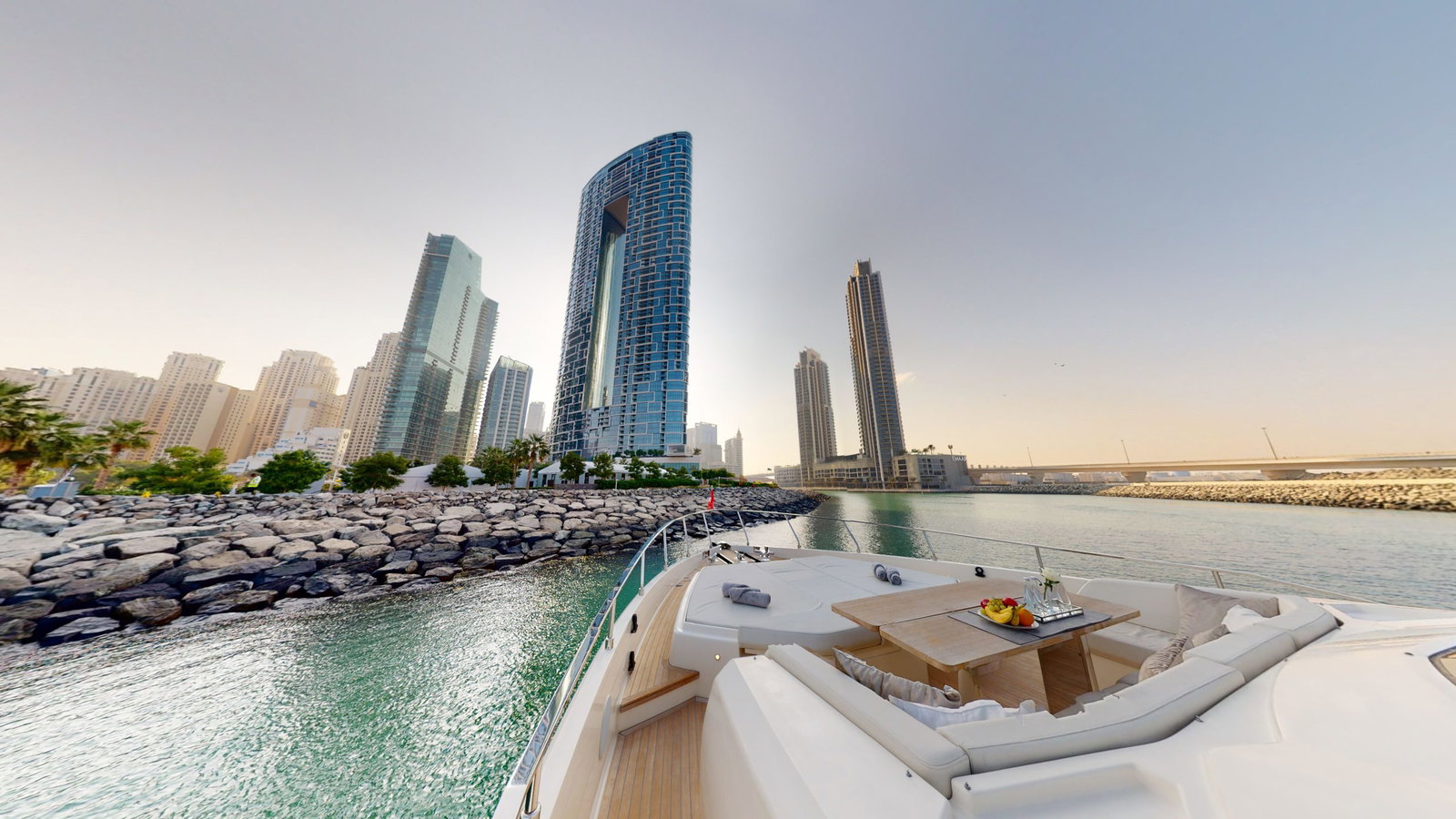 Ferretti 780 luxury yacht foredeck lounge with Dubai skyline view