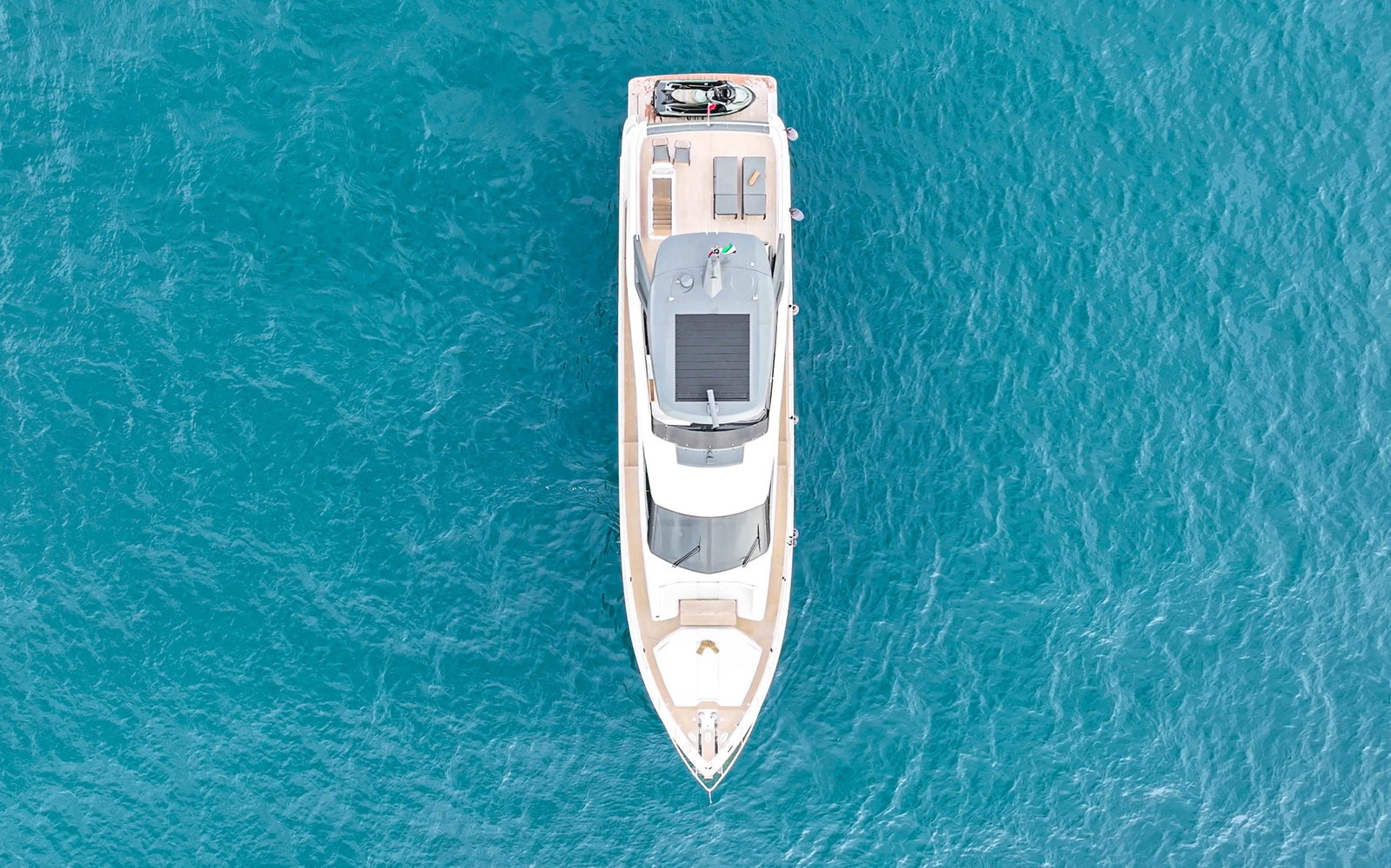 Aerial top view of Ferretti 780 superyacht in turquoise Dubai waters