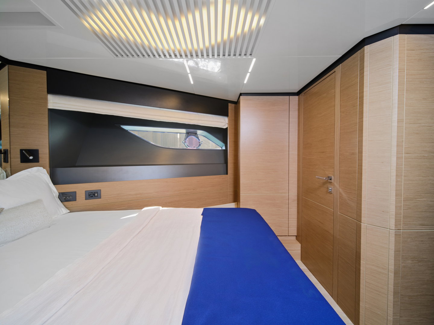 Guest cabin on Ferretti 780 yacht with double bed and wood panel walls