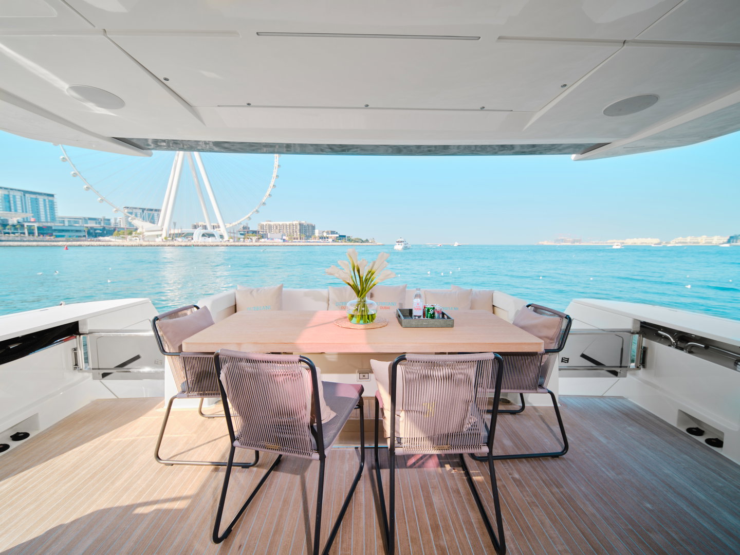 Outdoor dining area on Ferretti 780 yacht with sea views