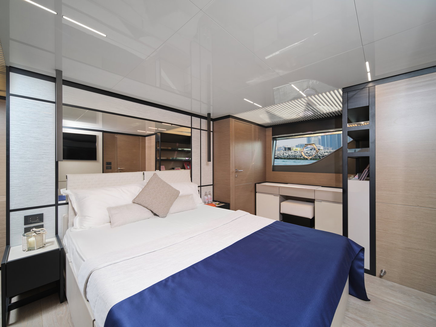 Master bedroom on Ferretti 780 yacht with large bed and storage