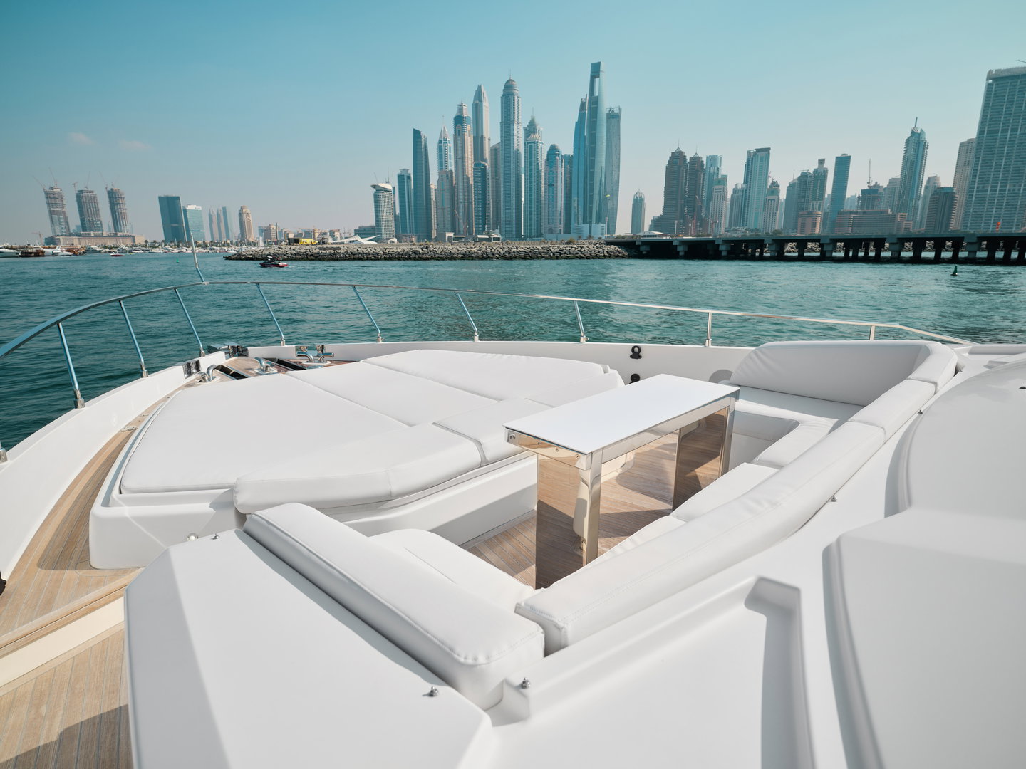 Bow seating area on Ferretti 780 yacht with Dubai skyline view