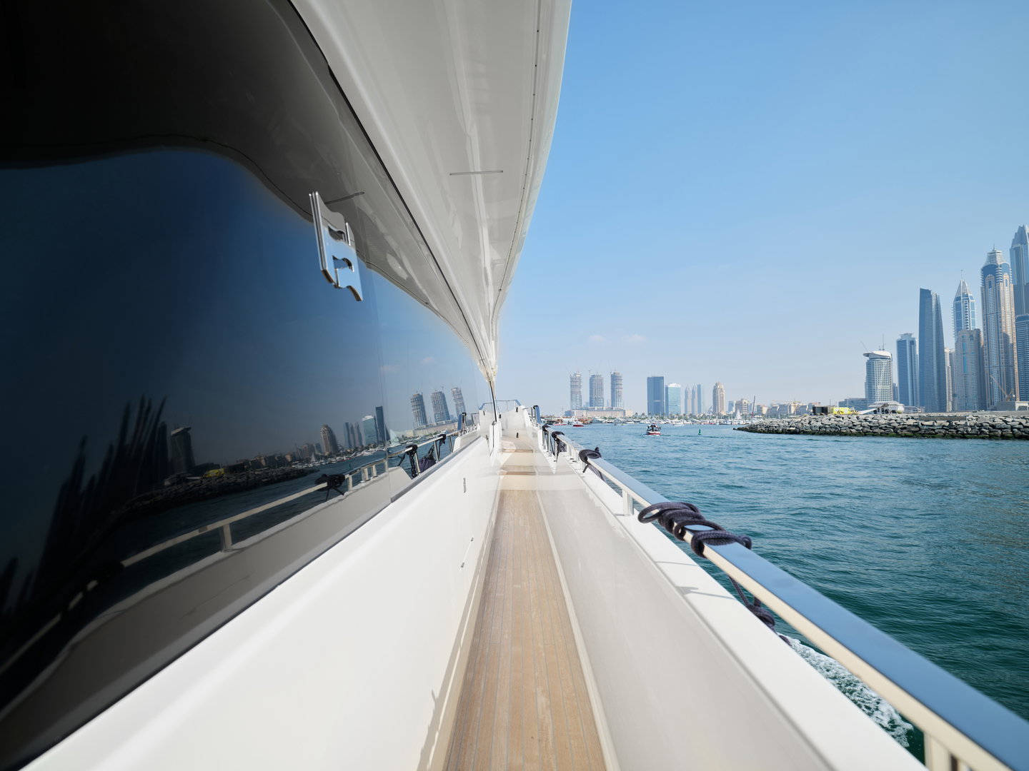 Side deck walkway on Ferretti 780 yacht with Dubai skyline view