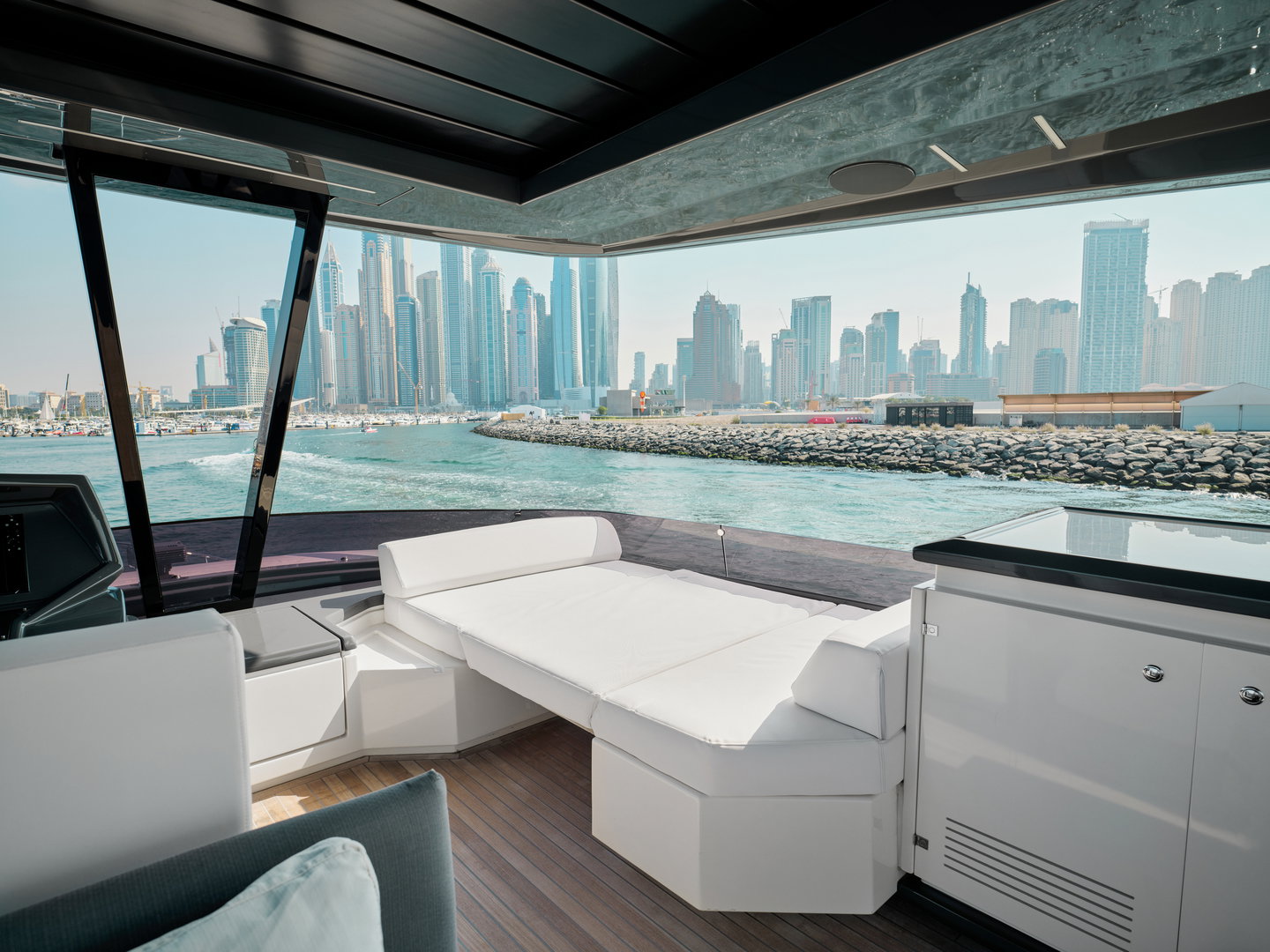 Enclosed upper lounge on Ferretti 780 yacht with Dubai skyline view
