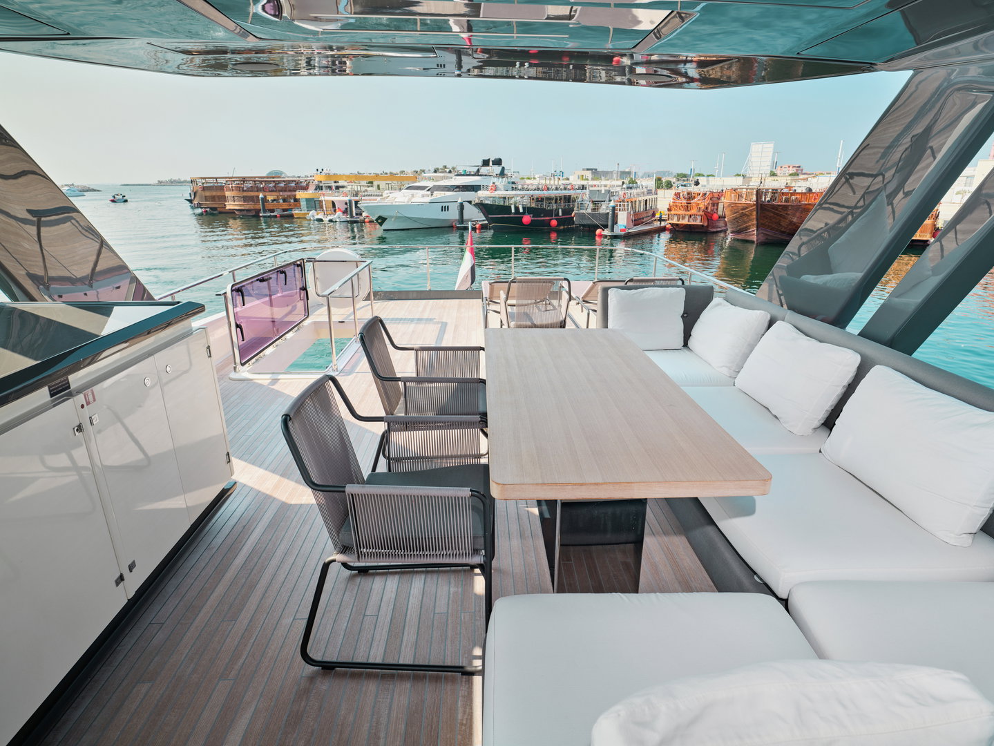 Aft deck lounge and dining area on Ferretti 780 yacht at sunset