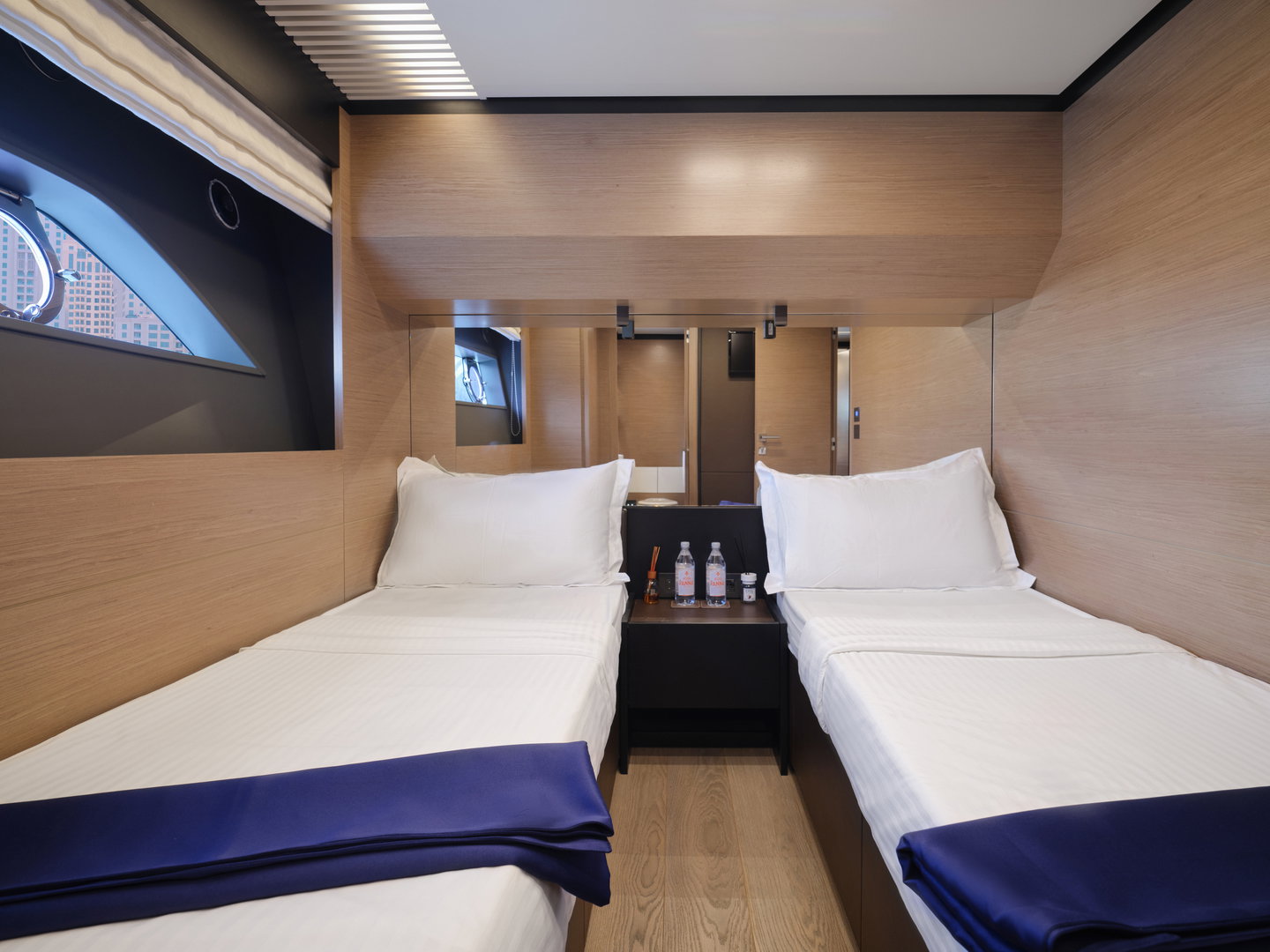 Twin guest cabin on Ferretti 780 yacht with modern bedding and storage