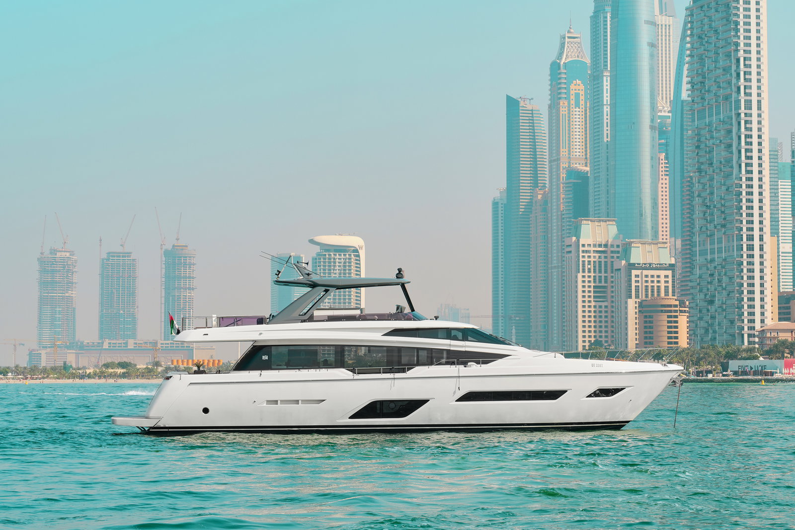 Side profile of Ferretti 780 yacht cruising near Dubai coastline